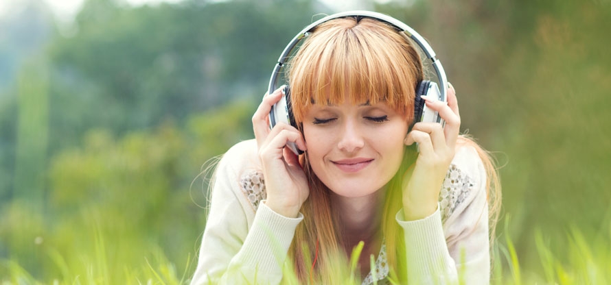 Lady in field with headphones