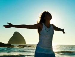 Lady on beach outstretched