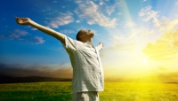 Man with arms outstretched in field